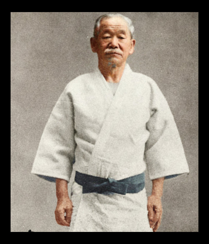 Kano Jigoró, founder of Kodokan judo, in his later role as Olympics promoter, with text and signature on a black and white photo.