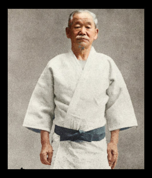 Kano Jigoró, founder of Kodokan judo, in his later role as Olympics promoter, with text and signature on a black and white photo.