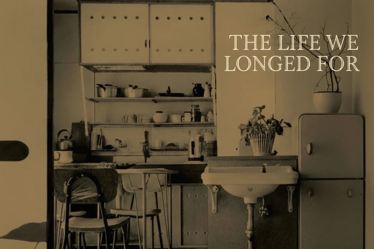 Book cover of 'The Life We Longed For' by Laura Neitzel with a kitchen scene.